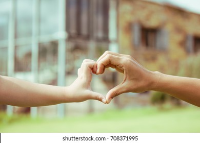 Hand Mom And Child On Heart-shaped Home Background Blurred, Natural Tones Vintage Style. Show The World You Love Love Family Between Two People.Let's Stay Together Happy Mother's Day,