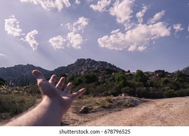 a hand and mountains