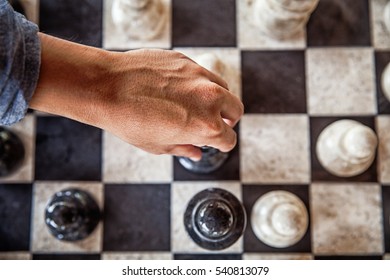A Hand Is Moving A Piece During A Chess Game (from Above)