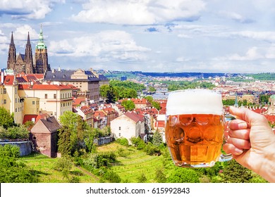 Hand with a mug of beer on the background of the panorama of Prague