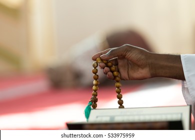 Hand of muslim black man people praying with mosque interior background