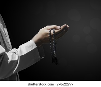 Hand of muslim people with praying gesture over dark background