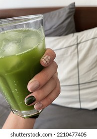 Hand With Nail Art Holding A Glass With Cold Matcha Tea