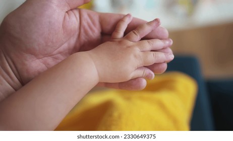 hand of a newborn baby. happy family toddler dream concept. father holding baby hand close-up. dad holding the hand of newborn toddler. child birth lifestyle protection care concept - Powered by Shutterstock