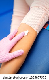 Hand Of Nurse Applying Cotton Swab To Arm Of Young Woman After Blood Sample In The Hospital