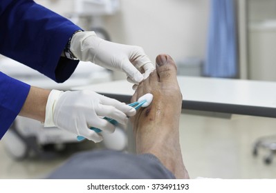 Hand Of Nurse Dressing Wound For Patient's Foot