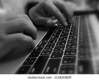 Hand o  keyboard​of computer. Black and white, blurred​ view. - Shutterstock ID 1118343839