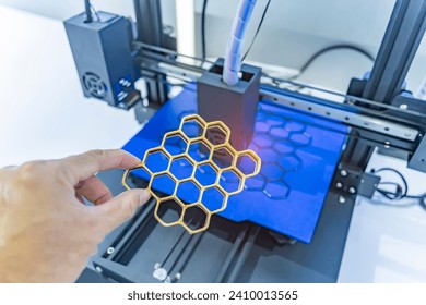 hand with Object printed on 3d printer close-up.