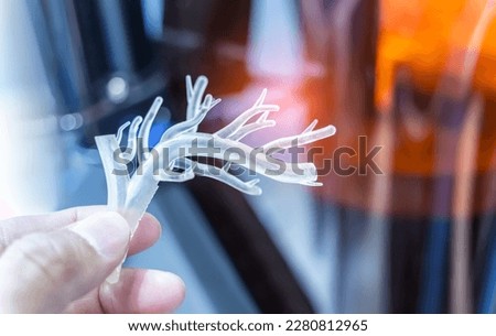 hand with object in shape of medically accurate a human blood vessel printed on 3d printer