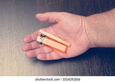 Hand Offering A Cigarette And Lighter, Toned