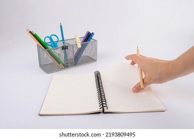 Hand With Office Pen And Pencil Holder. Isolated On White Background.