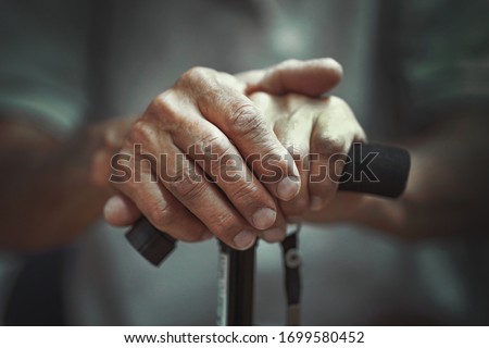 Hand of a old man holding a cane. Senior Man Holding Cane. Close-up Of old man Hands On Walking Stick.