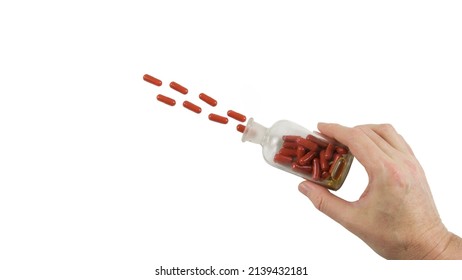 
Hand With An Old Pharmacy Bottle And Flying Capsules. Photo Isolated On White Background. Medication Use 