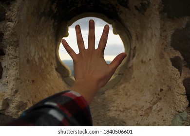 Hand is in a old window
