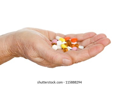 Hand Of The Old Woman With Pills.  Isolated On White Background