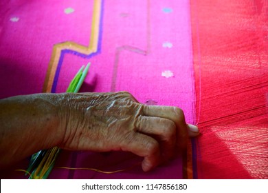 Hand of old woman she weaving