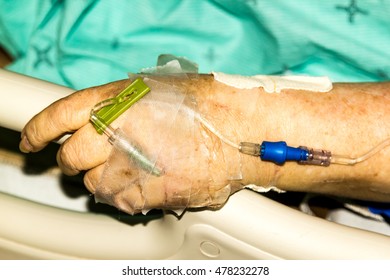 Hand Of A Older Woman With IV In A Hospital.