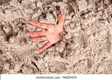 Hand On A Beach Sinking Or Drowning In Quicksand