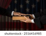 Hand on the Bible in court or the oath on the Constitution of the United States Books of American Wisdom during the inauguration in parliament. Oath of Office