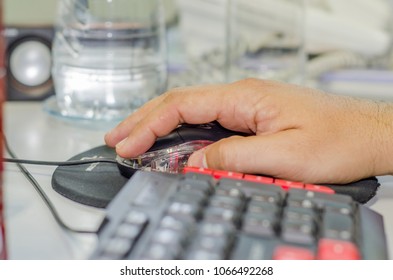Hand on computer mouse