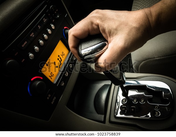hand on a gear\
shift, gear stick in a car