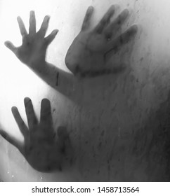 Hand On Glass Shower Door Stands Behind Steam Blurred Glass With Water Drops. Rest At Bathroom Black And White Background.