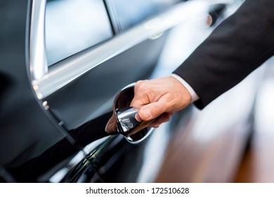 Hand On Handle. Close-up Of Man In Formalwear Opening A Car Door 