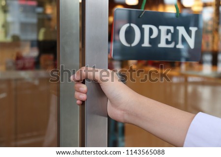 hand on handle door for open to entering restaurant 