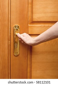 Hand On A Handle Wooden Door To Open Or Close It