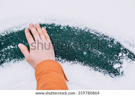 a hand on ice with snow