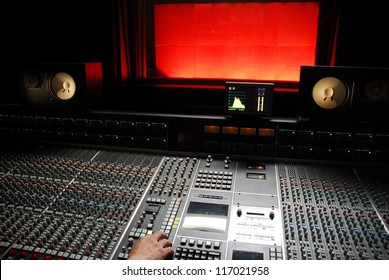 hand on mixer in the recording studio