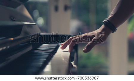 Hand On Piano Key