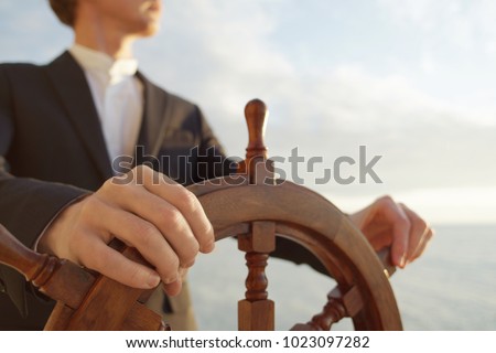 Hand on ship rudder.
