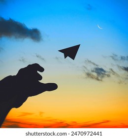 Hand on sky with moon and paper jet - Powered by Shutterstock