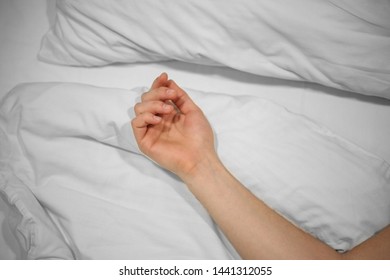 hand on a snow-white bed. Rest sleep. Sleeping man. Rest in bad - Shutterstock ID 1441312055