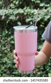 Hand On Thermos Tumbler Mug With Metal Drinking Straw, Stock Photo