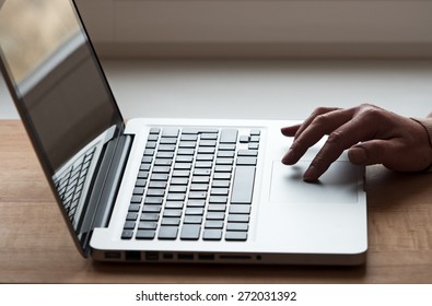 Hand On Touchpad Of Laptop In Back Light