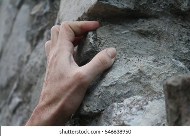 hand on wall climbing stone