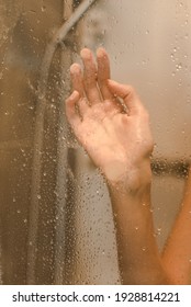 A Hand On A Wet Shower Door 