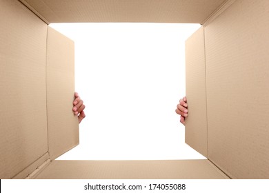 Hand Open Cardboard Box. Portrait From Inside The Box