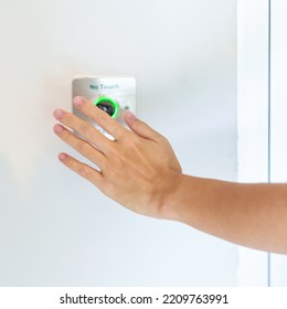 Hand Open The Door By No Touch Sensor Switch On The Wall At Office Or Apartment. Contactless, Modern, Technology And Safety Concept