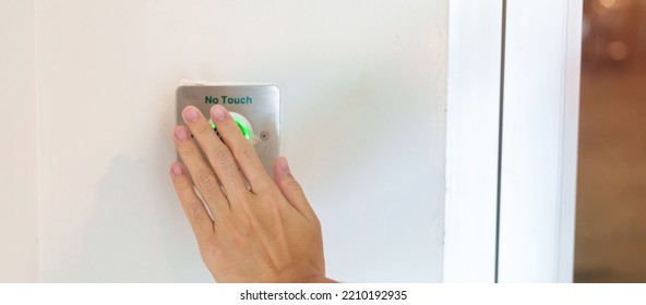 Hand Open The Door By No Touch Sensor Switch On The Wall At Office Or Apartment. Contactless, Modern, Technology And Safety Concept