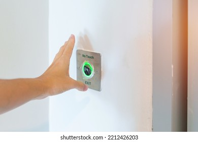 Hand Open The Door By No Touch Sensor Switch On The Wall At Office Or Apartment. Contactless, Modern, Technology And Safety Concept