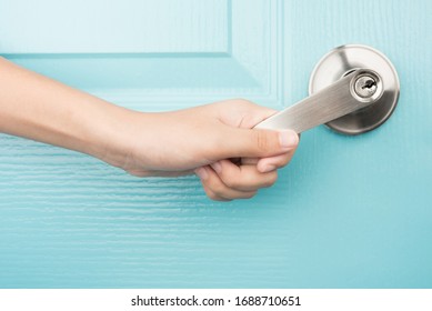 Hand Open Door Knob Blue Background