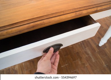 Hand open drawer box of wooden table, stock photo