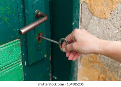 Hand Open Old Door With Old Key