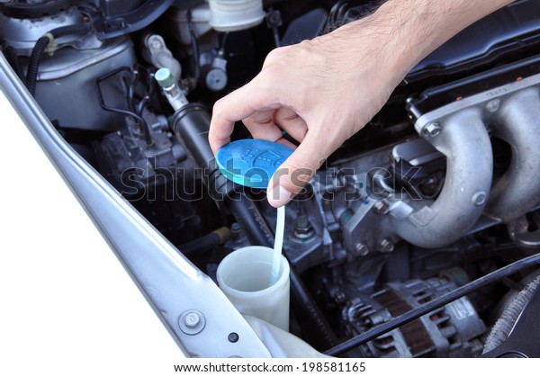 Hand opening car windscreen washer tank checking\
water level