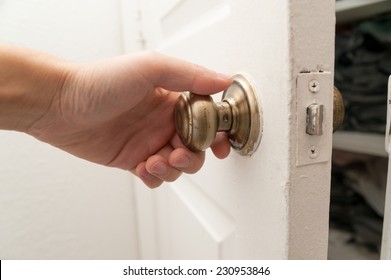 Hand Opening The Closet Door