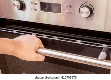 Hand Opening The Oven Door