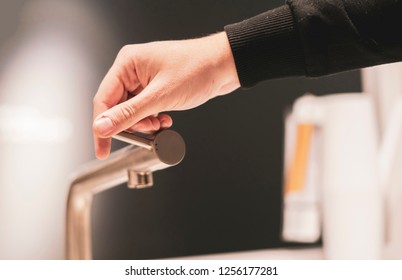 Hand Opens The Kitchen Water Faucet Tap Close Up